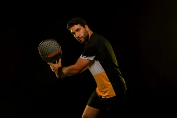 Padel Tennis Player with Racket in Hand. Paddle tenis, on a blue background. Download in high resolution. © Mike Orlov