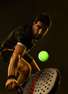 Padel Tennis Player with Racket in Hand. Paddle tenis, on a blue background. Download in high resolution.