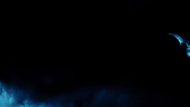 Dramatic lightning strike and flashing thunderclouds in dark stormy night sky loop