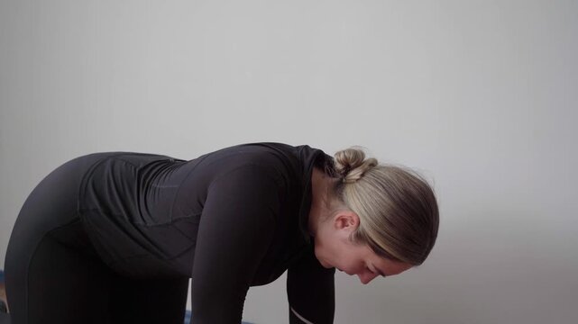 Side close-up of a person on hands and knees performing controlled quadruped scapular push-ups to build shoulder stability and upper back control.