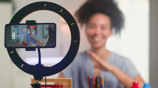 Smiling Black Woman With Natural Hair Teaches Remotely Online Using Smartphone And Ring Light