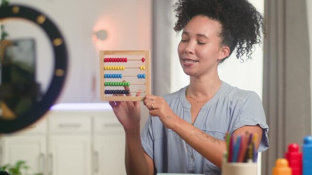 Engaging Black Woman Online Teacher Demonstrates Math with Abacus for Remote Primary Learning