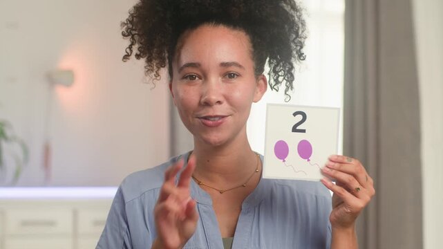 Smiling Black Woman Online Teacher Demonstrating Numbers and Counting for Primary School Math