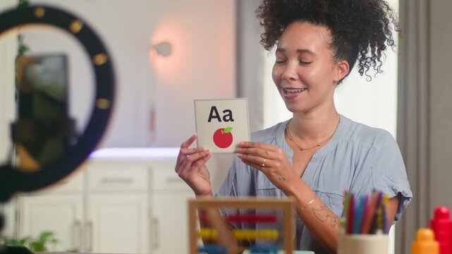 Online Teacher with Natural Hair Demonstrating English Alphabet for Remote Learning