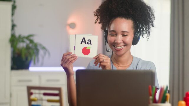 Smiling Black Woman Online Teacher Demonstrates English Alphabet Flashcards During Remote Lesson