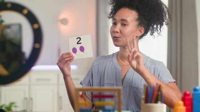 Engaging Online Math Lesson: Black Woman Teacher Uses Flashcards for Primary Education