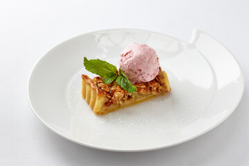 Apple tart with raspberry ice cream and mint leaf © EdienuFoto