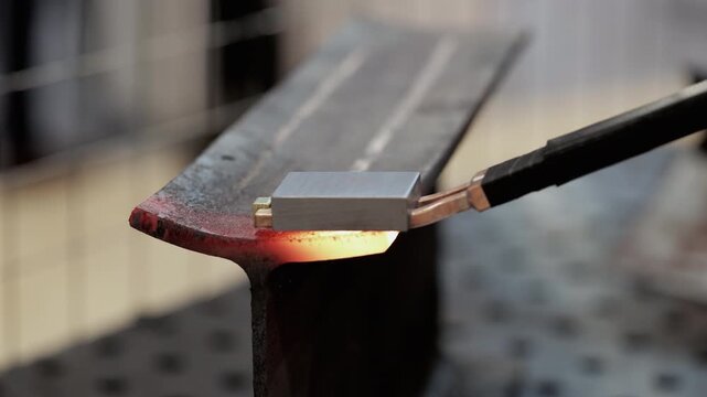 Induction heating of steel with electromagnetic fields raises temperature within metal closeup.mission-free metal processing in a modern factory.