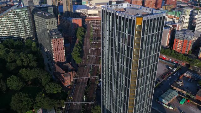 Aerial Video Featuring the Victoria Riverside Residential Tower in Manchester Victoria North with a Tram Travelling Toward Victoria Station. 