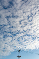 Obraz premium Utility pole under a cloudy sky