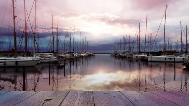 empty wooden jetty in foreground of blurred sailboat marina in Wendtorf, outer Kiel Fjord, Schleswig Holstein, Germany, moody scenery with copy space 