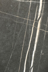 Fototapeta premium Black marble surface showing white vein patterns