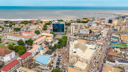 Aerial view showing urban landscape, busy streets, and the atlantic ocean coastline in accra, ghana © Roger
