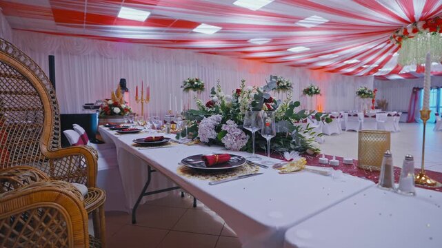 Elegant Wedding Head Table with Floral Centerpiece and Peacock Chairs