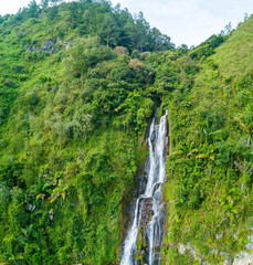 Aerial drone view of greenery hills with Situmurun Waterfall near Toba Lake at Lumban Juju in Toba, Sumatera Utara, Indonesia © MUAZ JAFFAR