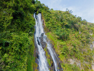Aerial drone view of greenery hills with Situmurun Waterfall near Toba Lake at Lumban Juju in Toba, Sumatera Utara, Indonesia © MUAZ JAFFAR