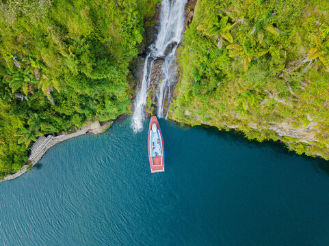 Aerial drone view of greenery hills with Situmurun Waterfall near Toba Lake at Lumban Juju in Toba, Sumatera Utara, Indonesia