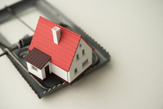 House in rat trap on white background copy space. Real estate, property, land, rental, mortgage closing scams concept. Protect money from real estate scams when buying, rental a home.