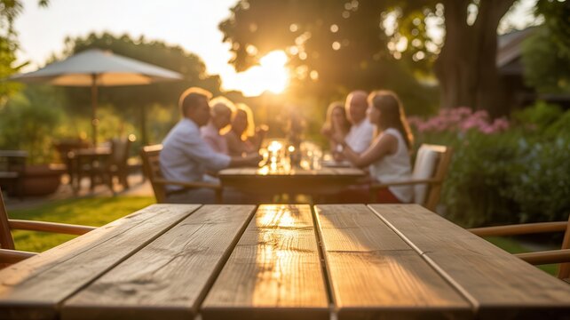 Group of friends dining outdoors at sunset. Social dining concept.