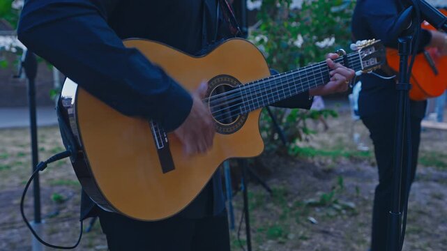 Close Up of Musician Playing Classical Guitar at Outdoor Wedding