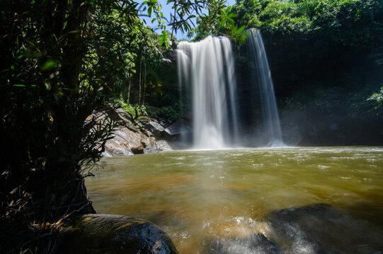 Serene Waterfall Surrounded by Dense Green Tropical Jungle Landscape