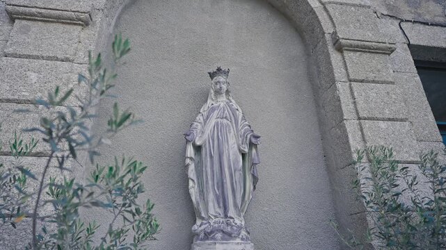Statue of the Virgin Mary on Church Wall Before Wedding Ceremony
