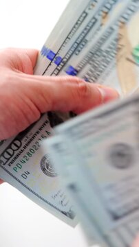Male hands counting US Dollar bills, close-up