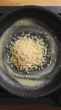 Chopped nuts pour onto melted butter in hot frying pan. Brown butter adds nutty, caramel flavor to homemade baked goods. Brown butter works great for cookies, muffins, pound cake or brownies.