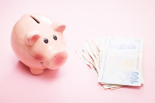 pink piggy bank for saving money on a light background