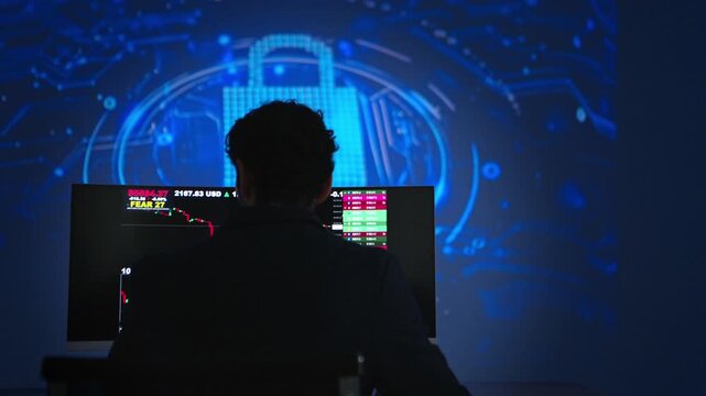Software developer monitoring artificial intelligence systems and programming code on multiple displays in a modern technology workspace