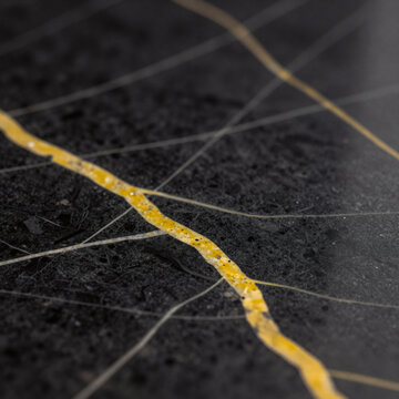 Futurist Marble Bathroom. A Black Marble Background Featuring Yellow Veins