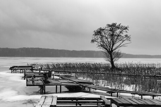 Graphic Lines of Wooden Fishing Piers on Frozen Lake Surface in Winter