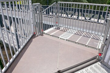 Fototapeta premium High angle view of temporary modular access platform with safety handrails and anti-slip decking mounted on bridge, urban engineering concept