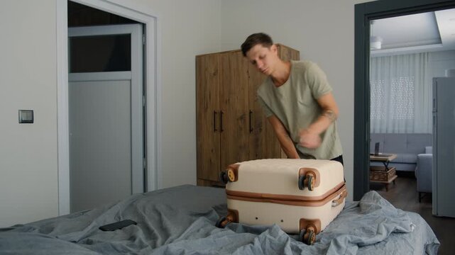 Digital nomad lifestyle and expat life. Remote worker packing suitcase and preparing belongings for the next relocation in temporary accommodation