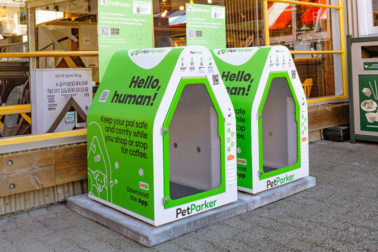 Vancouver, BC, Canada-September 4, 2024: Two Pet Parkers or Dog Parkers outside of retail store. This is a small cube or dog house where pet owners can safely "park" their dogs  while shopping.