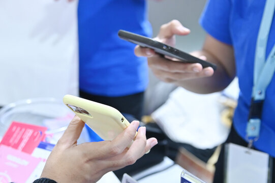 close-up shot of two people holding smartphones facing each other during a digital transaction or data exchange.