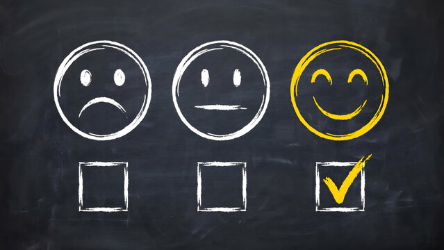 Feedback survey choice with happy face icon selected on a blackboard