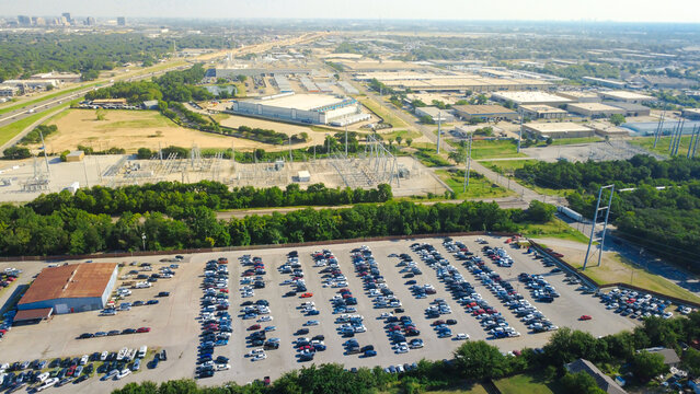 Expansive industrial sectors stretch past electrical substations flanking S. Irving Heights Drive illustrating commercial utilization. Massive logistics parks operate continuously in Irving, TX