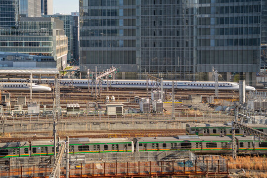 Tokyo, Japan - December 29, 2025:  View of train tracks at Tokyo Station with with Shinkansen bullet trains and various commuter trains as seen from above.