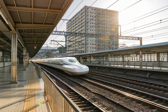 Tokyo, Japan - December 29, 2025:  White Shinkansen bullet train passing through Tokyo Train Station at high speed.