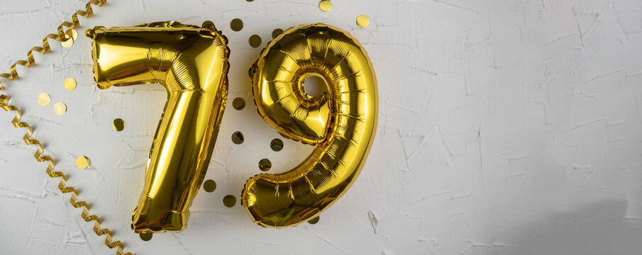 Yellow Gold foil balloon number seventy-nine on white background. Birthday card with lettering 79. Anniversary concept. For anniversary, birthday, wedding event, new year celebration.