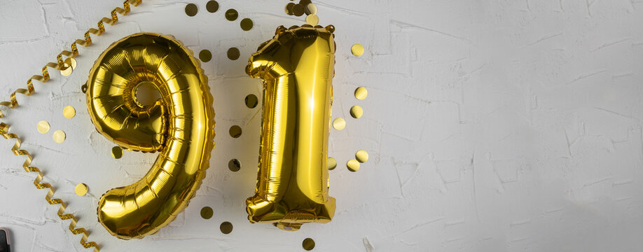 Yellow Gold foil balloon number ninety-one on white background. Birthday card with lettering 91. Anniversary concept. For anniversary, birthday, wedding event, new year celebration. Banner
