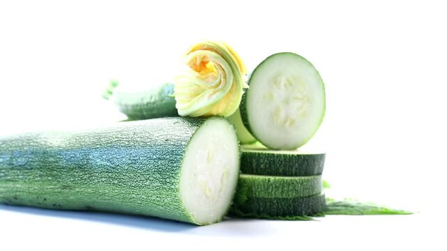 Organic summer squash with blossoms on minimal white studio background