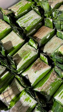 Grilled glutinous rice wrapped in a banana leaf (lemper), filled with grilled chicken. A traditional Indonesian food.
