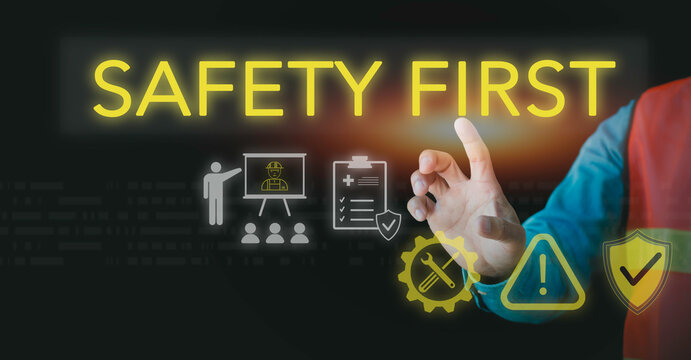 Engineer touching safety first virtual text with industrial icons. Concept of occupational hazard prevention, construction site health standards, risk assessment, and protective workplace training.