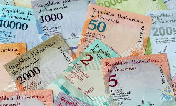 Venezuelan bolivar money bills in pile on table. Venezuela VES currency cash close up