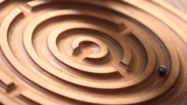 Wooden balance board with built in maze and rolling marble designed for children and adults, improving coordination, balance, focus and problem solving through interactive skill based exercise.