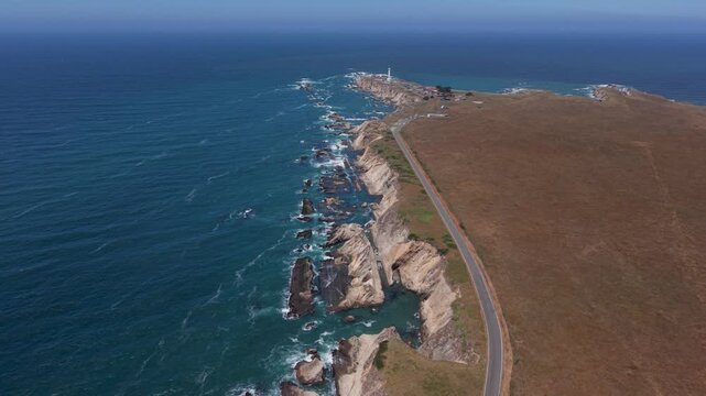 See aerial views of Point Arena Lighthouse, cliffs, and waves along the northern California coast near Mendocino.