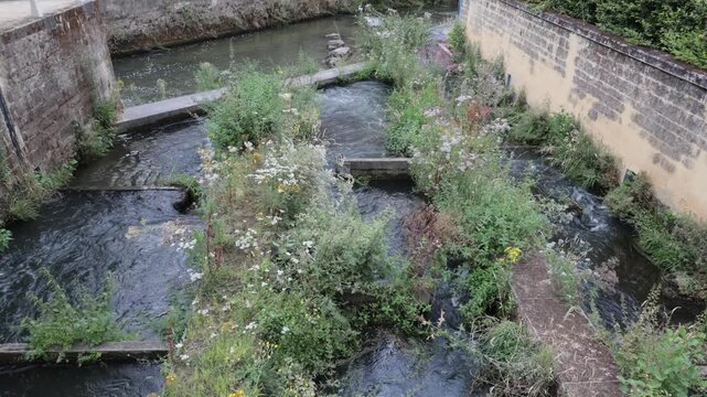 fish ladder on a fast flowing river outside a town 