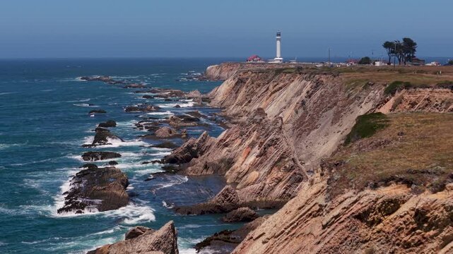Aerial views show Point Arena Lighthouse and cliffs along the northern California coast near Mendocino with ocean waves below.